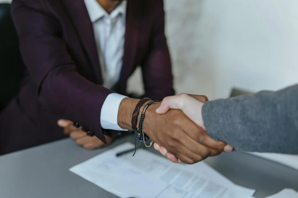 Two businessmen in a handshake– symbolizing global trade facilitated by genuine bank guarantees (BG) and standby letters of credit (SBLC) from General Credit Finance and Development Limited.