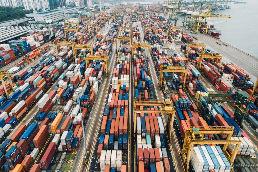 Seaport with cranes and shipping containers, symbolizing secure international trade facilitated by bank guarantees from General Credit Finance and Development Limited